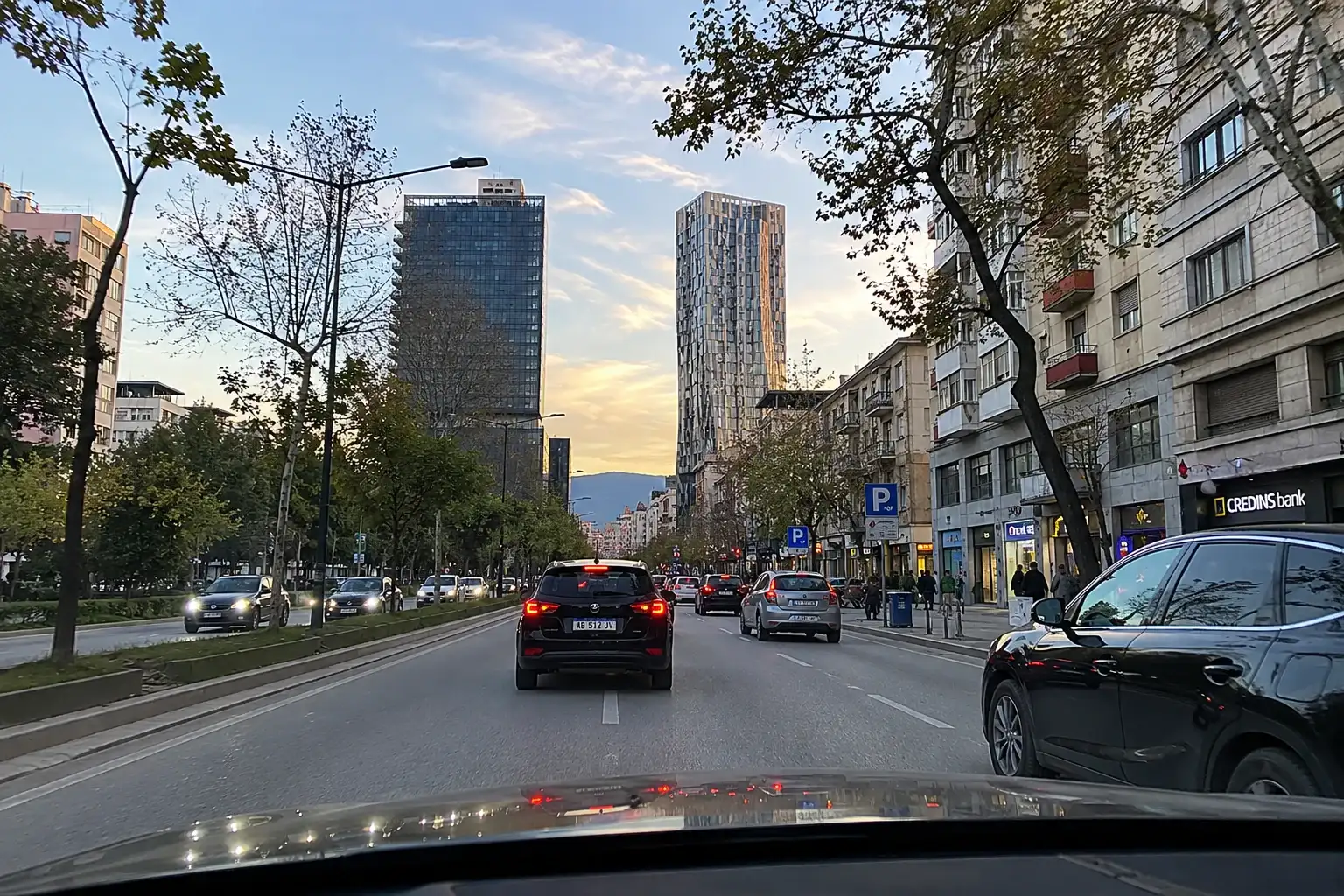 City driving in Tirana with cars on a main boulevard
